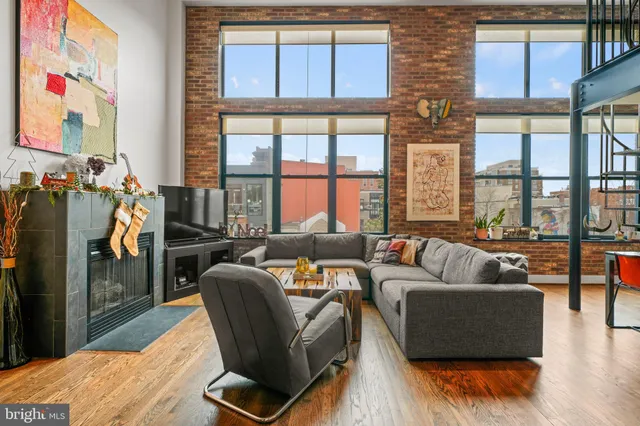 a living room with furniture and a floor to ceiling window