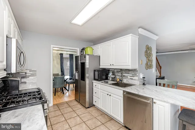 a kitchen with a sink appliances and cabinets