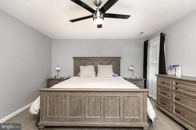 a bedroom with a bed and a dresser