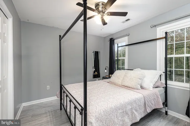 a bedroom with a large bed and a chandelier