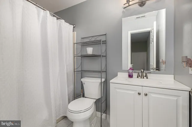 a bathroom with a sink toilet and mirror
