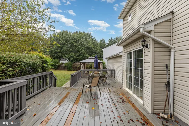 a view of a house with backyard and deck