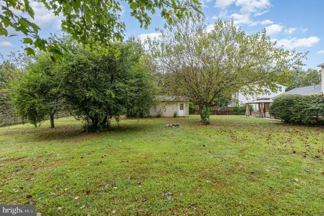 a yellow house with trees in front of it