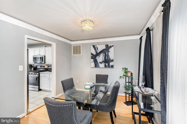 a view of a dining room with furniture and a kitchen