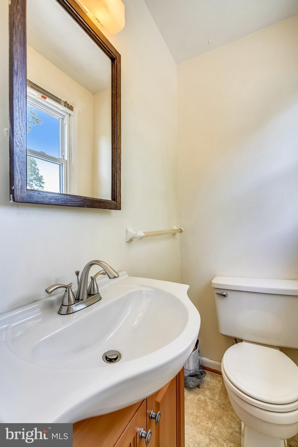 2518 Neudecker Road Westminster, MD 21157 - Photo 12 of 22 a bathroom with a toilet a sink and mirror