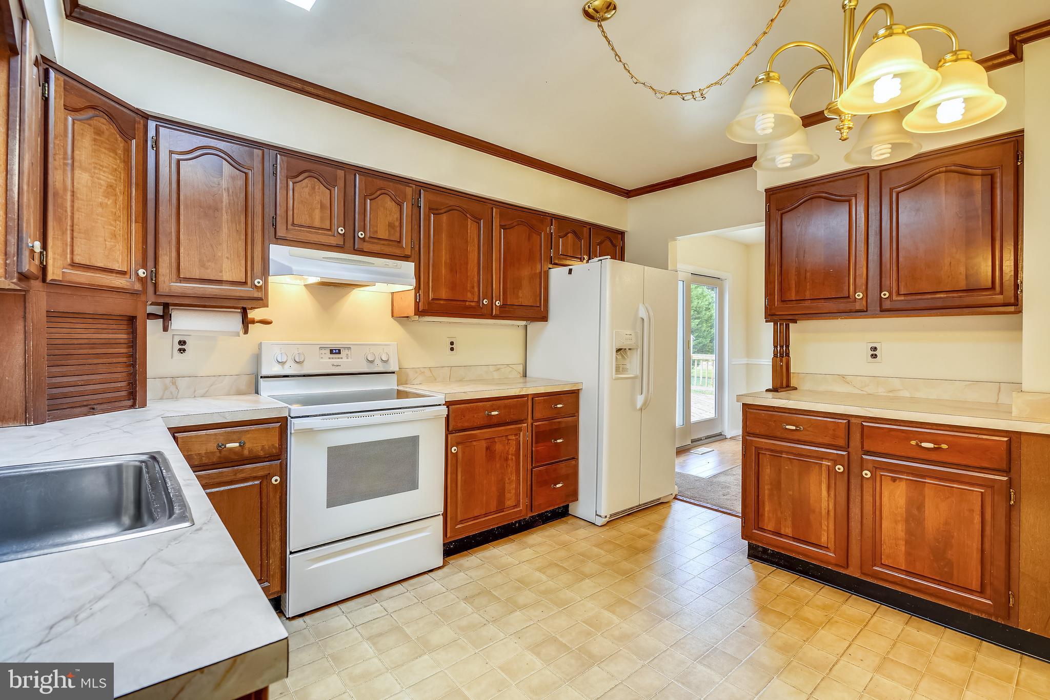 2518 Neudecker Road Westminster, MD 21157 - Photo 10 of 22 a kitchen with stainless steel appliances granite countertop a stove a sink dishwasher and a refrigerator with wooden cabinets