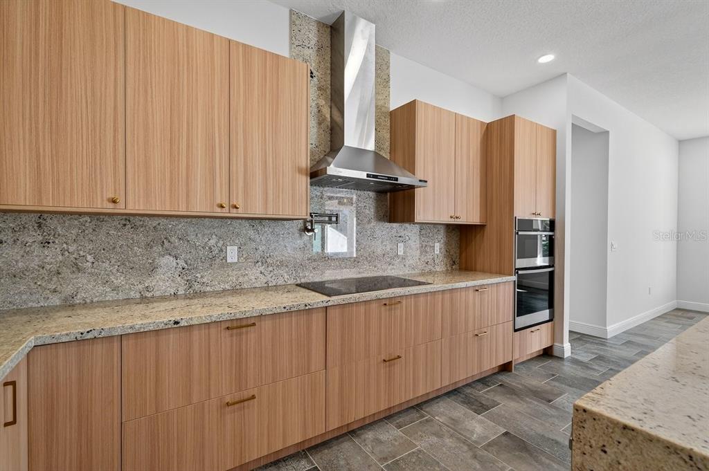7 Crandon Court Palm Coast, FL 32137 - Photo 19 of 72 a kitchen with stainless steel appliances granite countertop a sink a stove and a refrigerator
