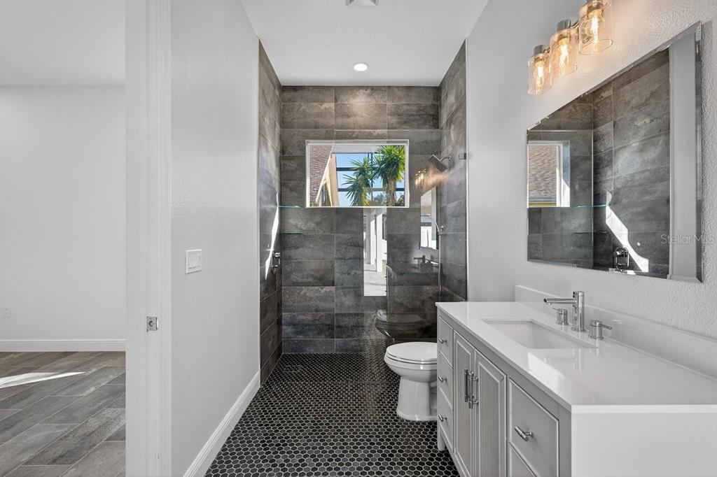 7 Crandon Court Palm Coast, FL 32137 - Photo 36 of 72 a bathroom with a sink a toilet and shower