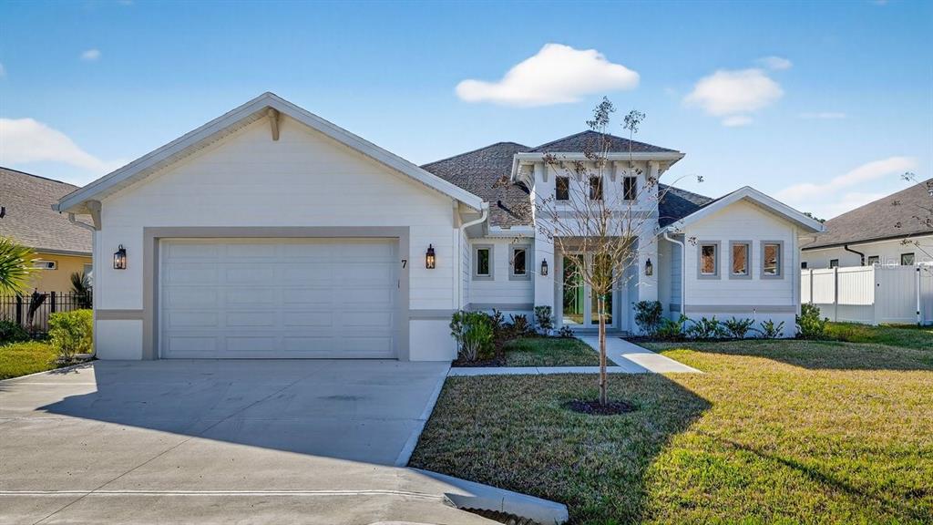 7 Crandon Court Palm Coast, FL 32137 - Photo 56 of 72 a front view of a house with garden