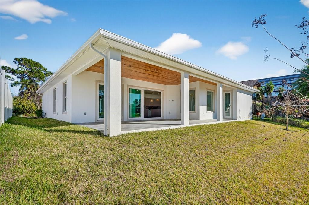 7 Crandon Court Palm Coast, FL 32137 - Photo 60 of 72 a view of house with backyard and glass windows