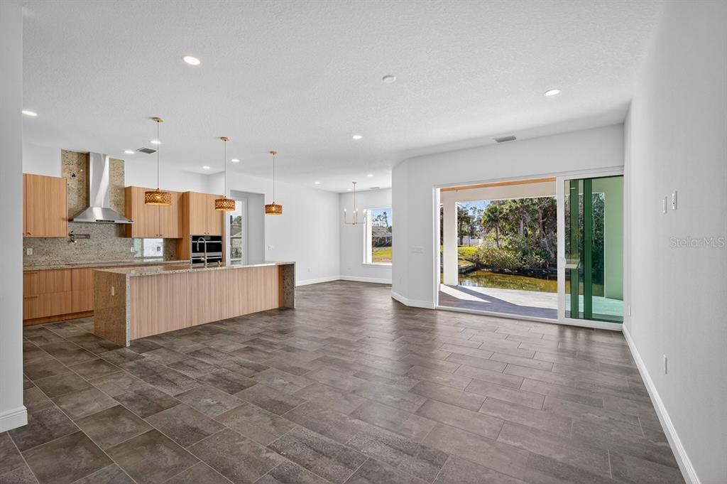 7 Crandon Court Palm Coast, FL 32137 - Photo 6 of 72 a view of kitchen with kitchen island granite countertop a stove a sink and a refrigerator