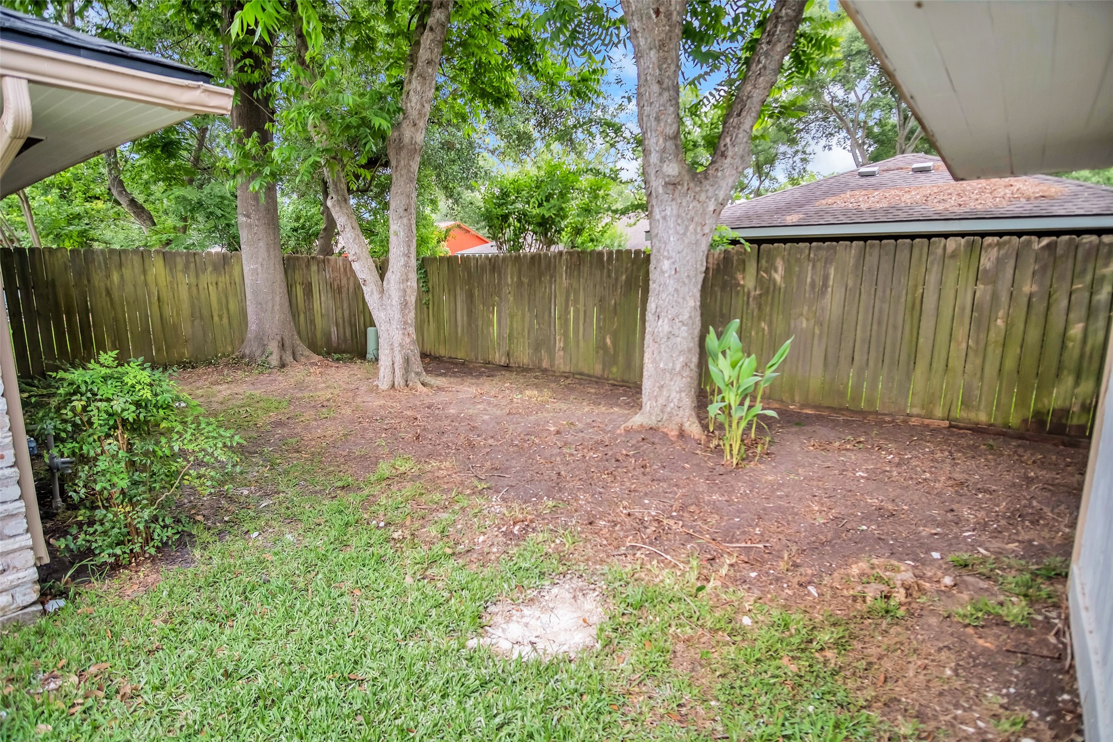 1715 Capstan Road Houston, TX 77062 - Photo 38 of 40 a view of a backyard with large tree and wooden fence