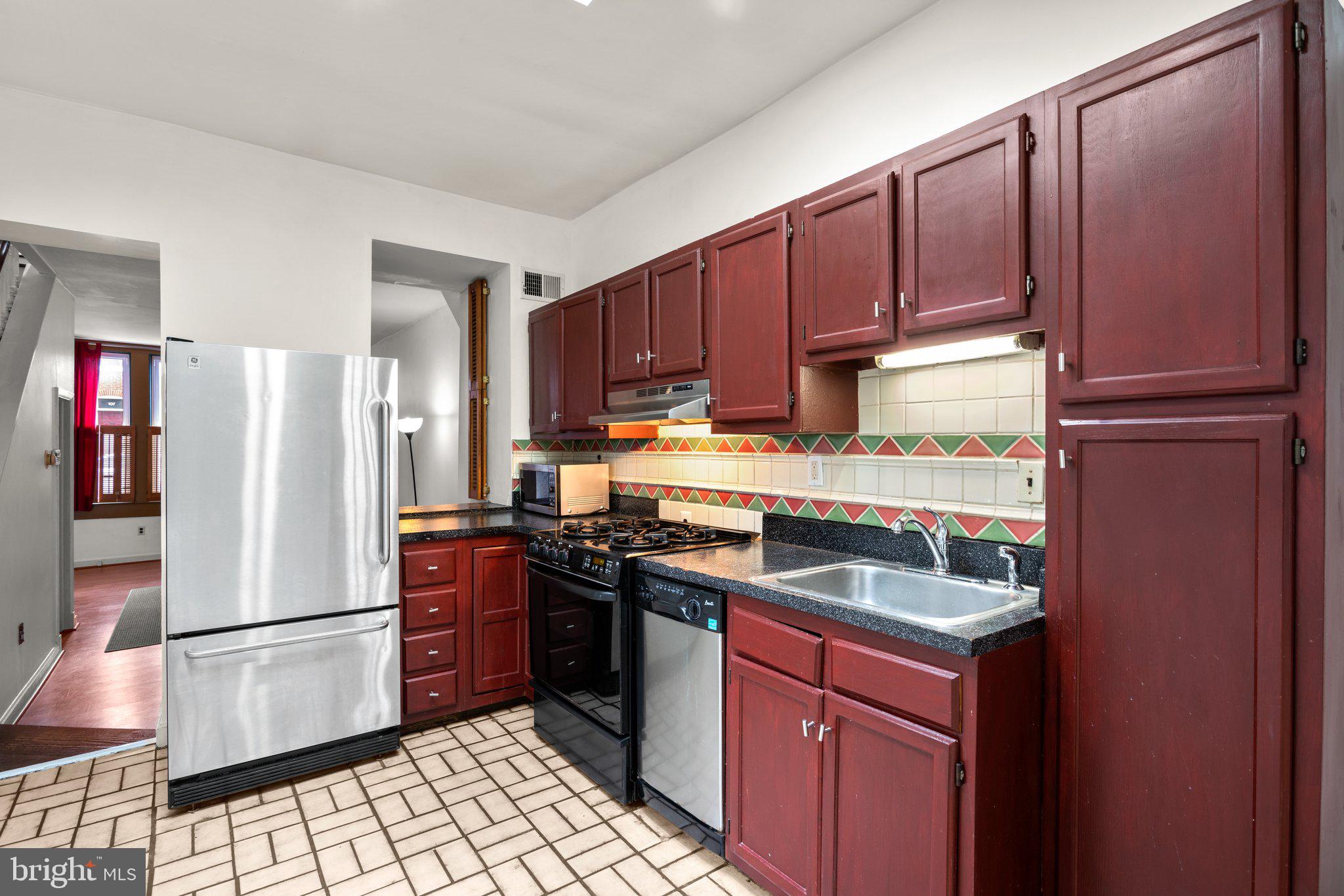 106 Scott Street Baltimore, MD 21201 - Photo 12 of 40 a kitchen with stainless steel appliances granite countertop a refrigerator stove and sink