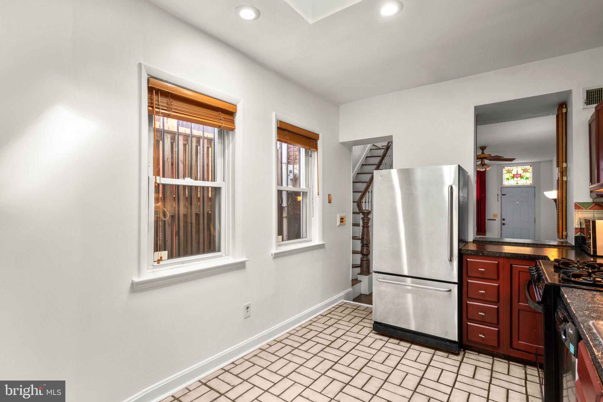 106 Scott Street Baltimore, MD 21201 - Photo 14 of 40 a kitchen with stainless steel appliances a refrigerator and a window