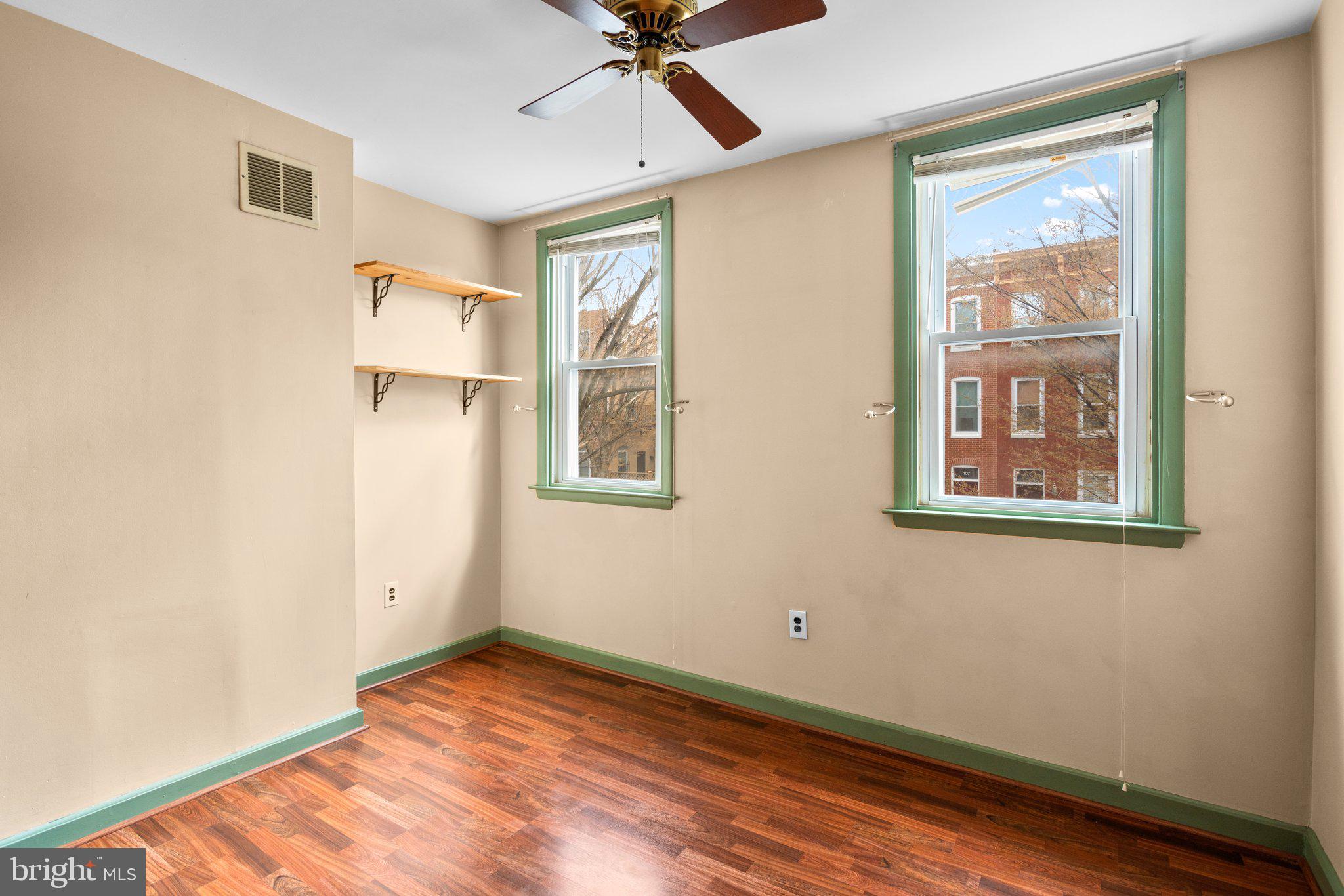 106 Scott Street Baltimore, MD 21201 - Photo 16 of 40 a view of an empty room with a window and wooden floor