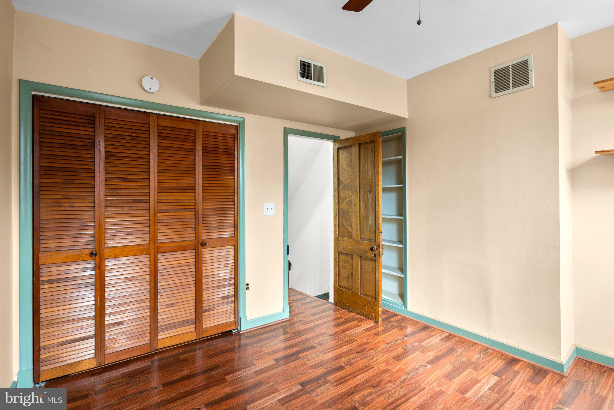 106 Scott Street Baltimore, MD 21201 - Photo 17 of 40 an empty room with wooden floor and windows