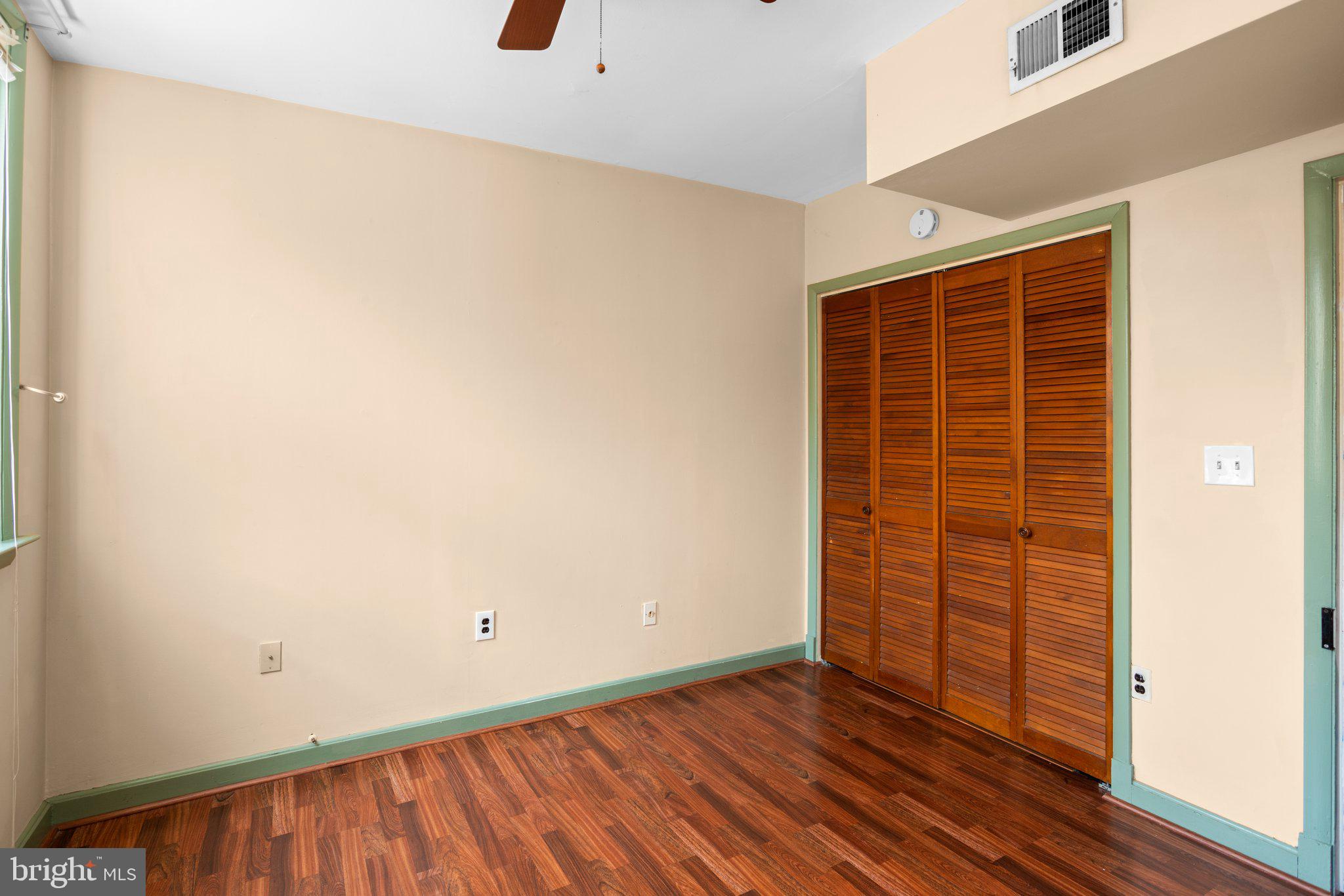 106 Scott Street Baltimore, MD 21201 - Photo 18 of 40 an empty room with wooden floor and windows
