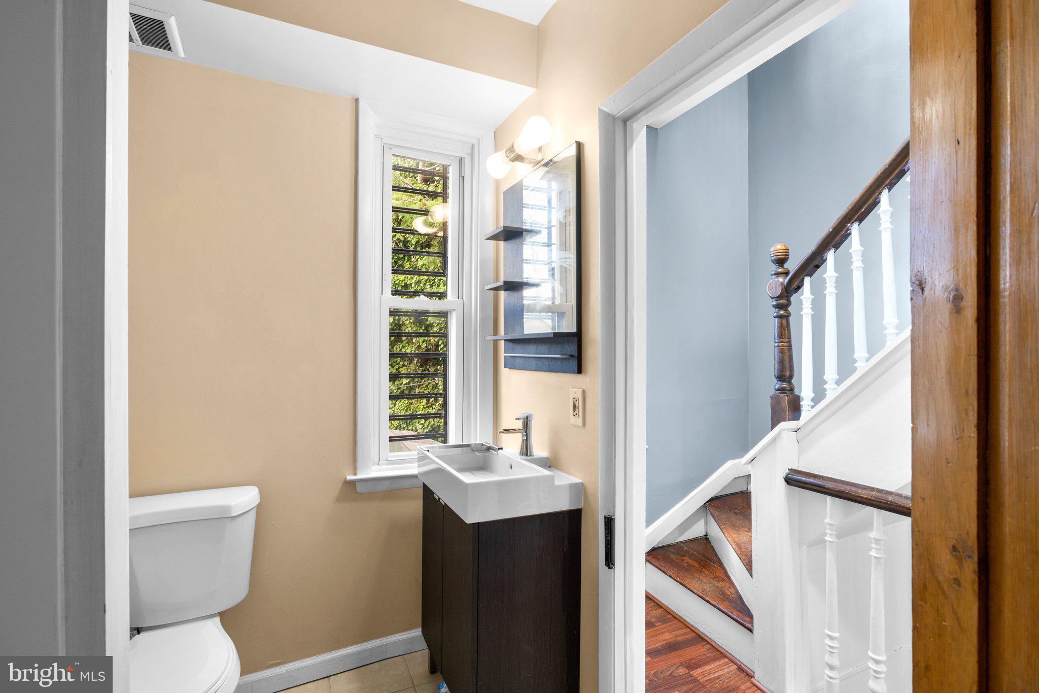 106 Scott Street Baltimore, MD 21201 - Photo 20 of 40 a bathroom with a sink a toilet and a window
