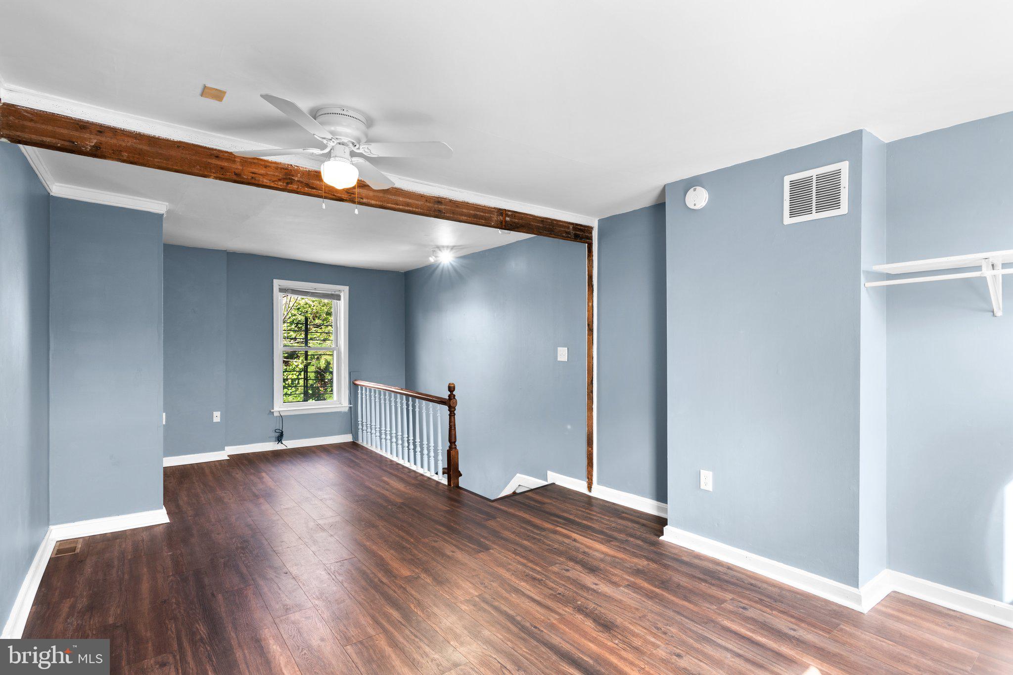 106 Scott Street Baltimore, MD 21201 - Photo 24 of 40 a view of an empty room with window and wooden floor