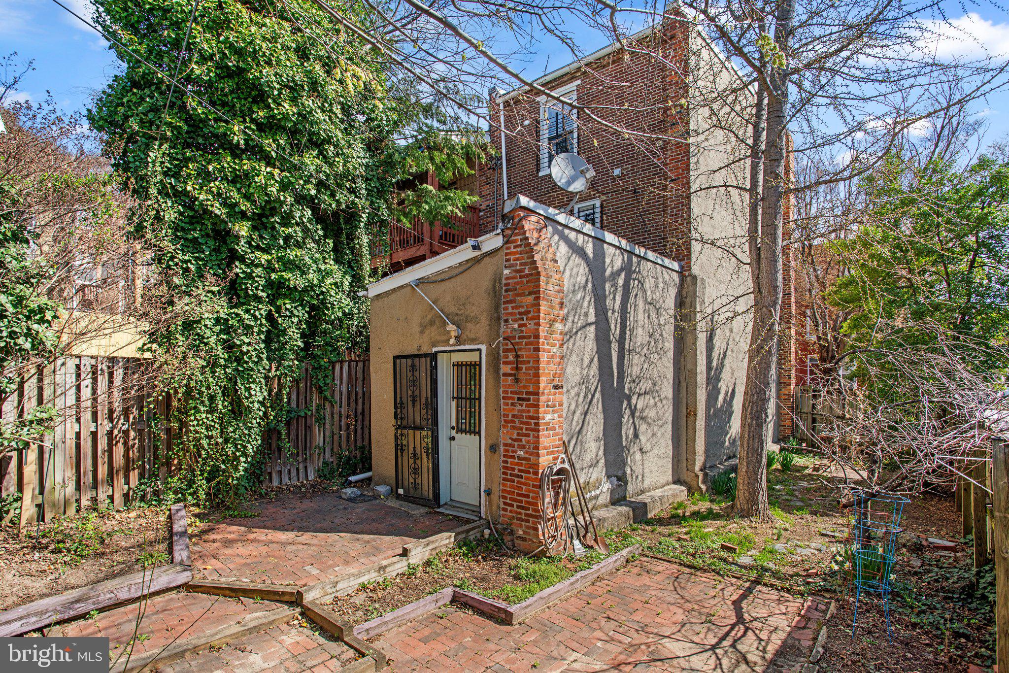 106 Scott Street Baltimore, MD 21201 - Photo 32 of 40 a view of a house with a yard