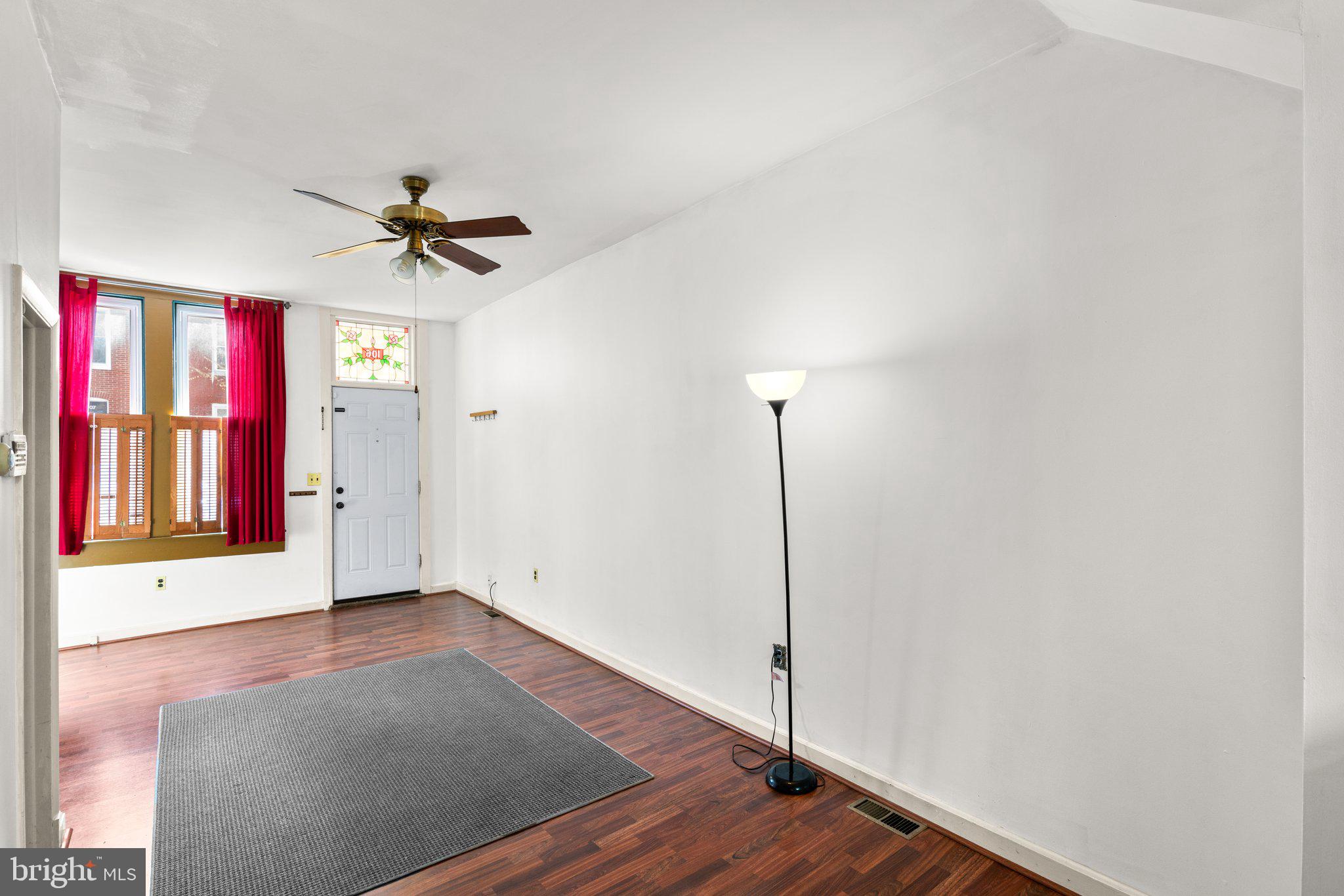 106 Scott Street Baltimore, MD 21201 - Photo 10 of 40 a view of an empty room with window and wooden floor