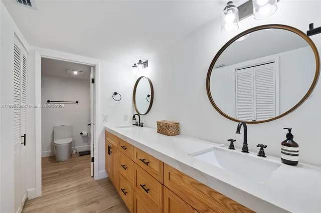 a spacious bathroom with a double vanity sink and a mirror