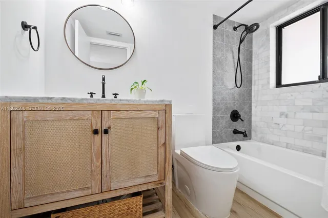 a bathroom with a sink mirror vanity and toilet