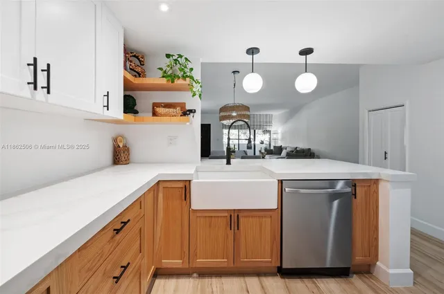a kitchen with kitchen island granite countertop a stove and a sink