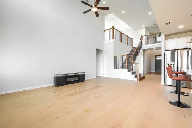 a view of an empty room with a kitchen