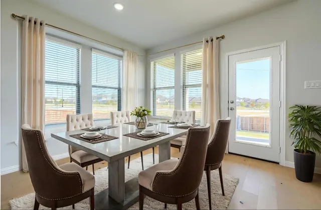 a dining room with furniture a large window and a livingroom