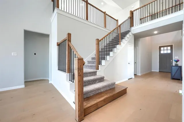 a view of staircase with lots of frames and white walls