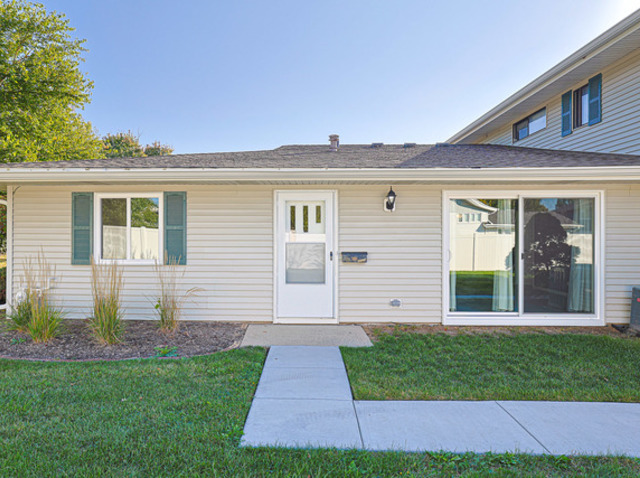 a view of a house with a small yard and a large window