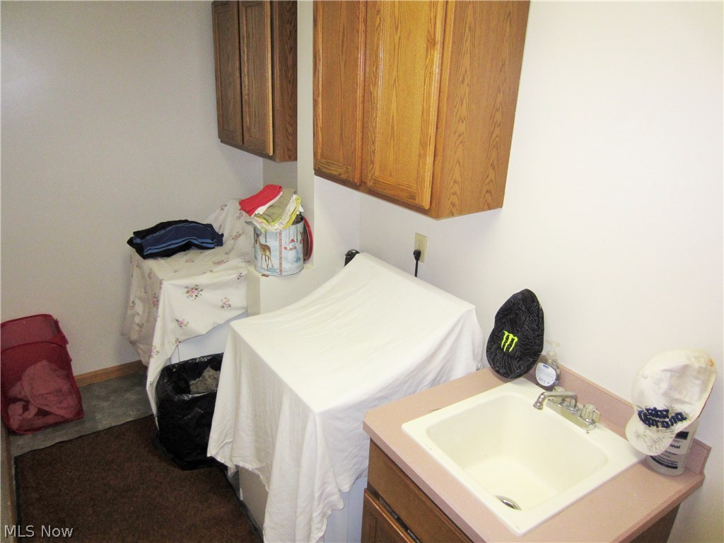 24021 Foster Road Litchfield, OH 44253 - Photo 12 of 34 Off the kitchen is the first floor laundry room with utility tub and extra storage!