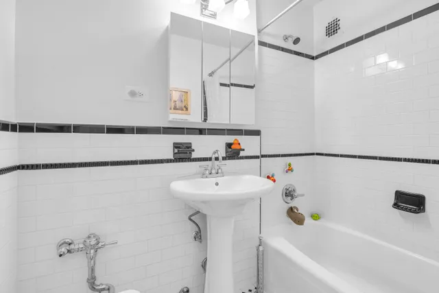 a bathroom with a sink a mirror and a bathtub