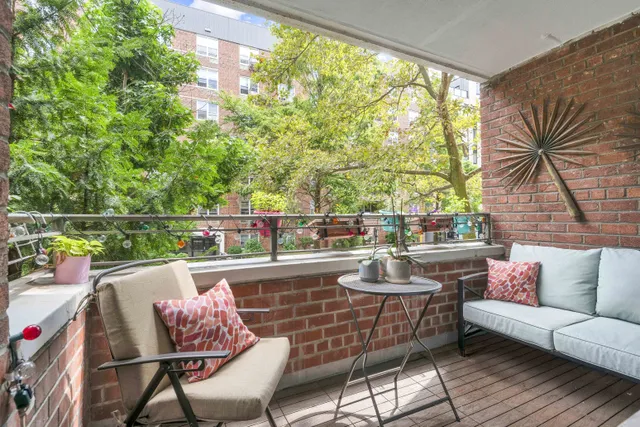 a view of a chairs and table in the balcony