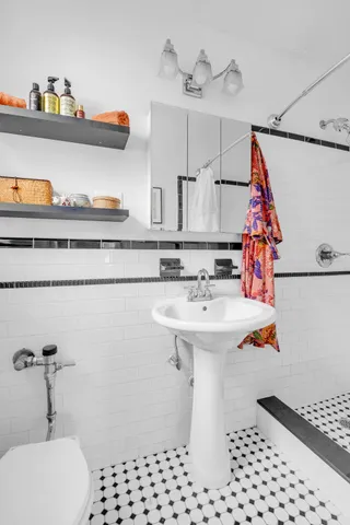 a bathroom with a sink a toilet and a shower