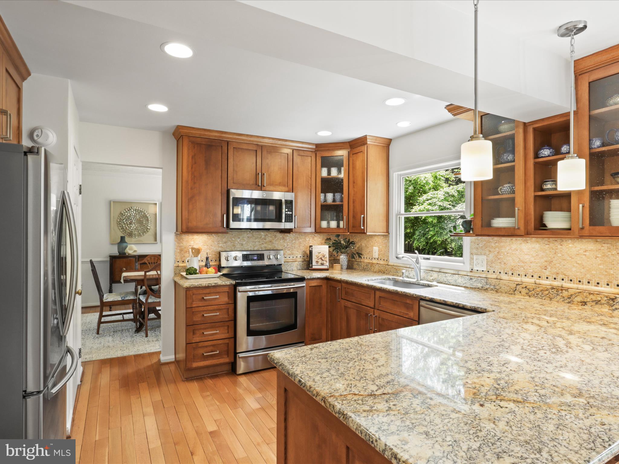 12021 Heather Down Drive Herndon, VA 20170 - Photo 15 of 47 a kitchen with stainless steel appliances granite countertop sink stove and refrigerator
