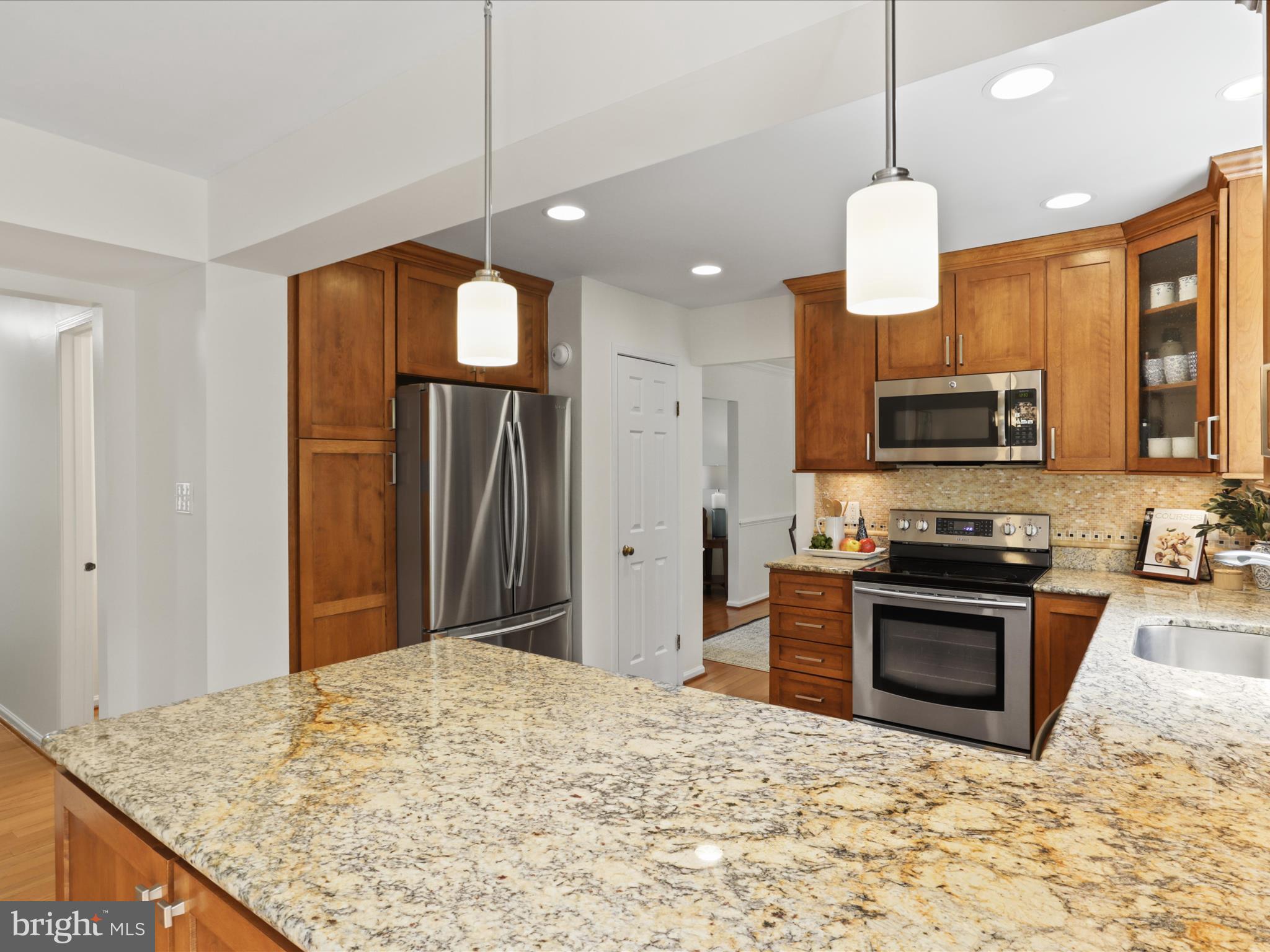 12021 Heather Down Drive Herndon, VA 20170 - Photo 17 of 47 a kitchen with stainless steel appliances granite countertop a stove refrigerator and microwave