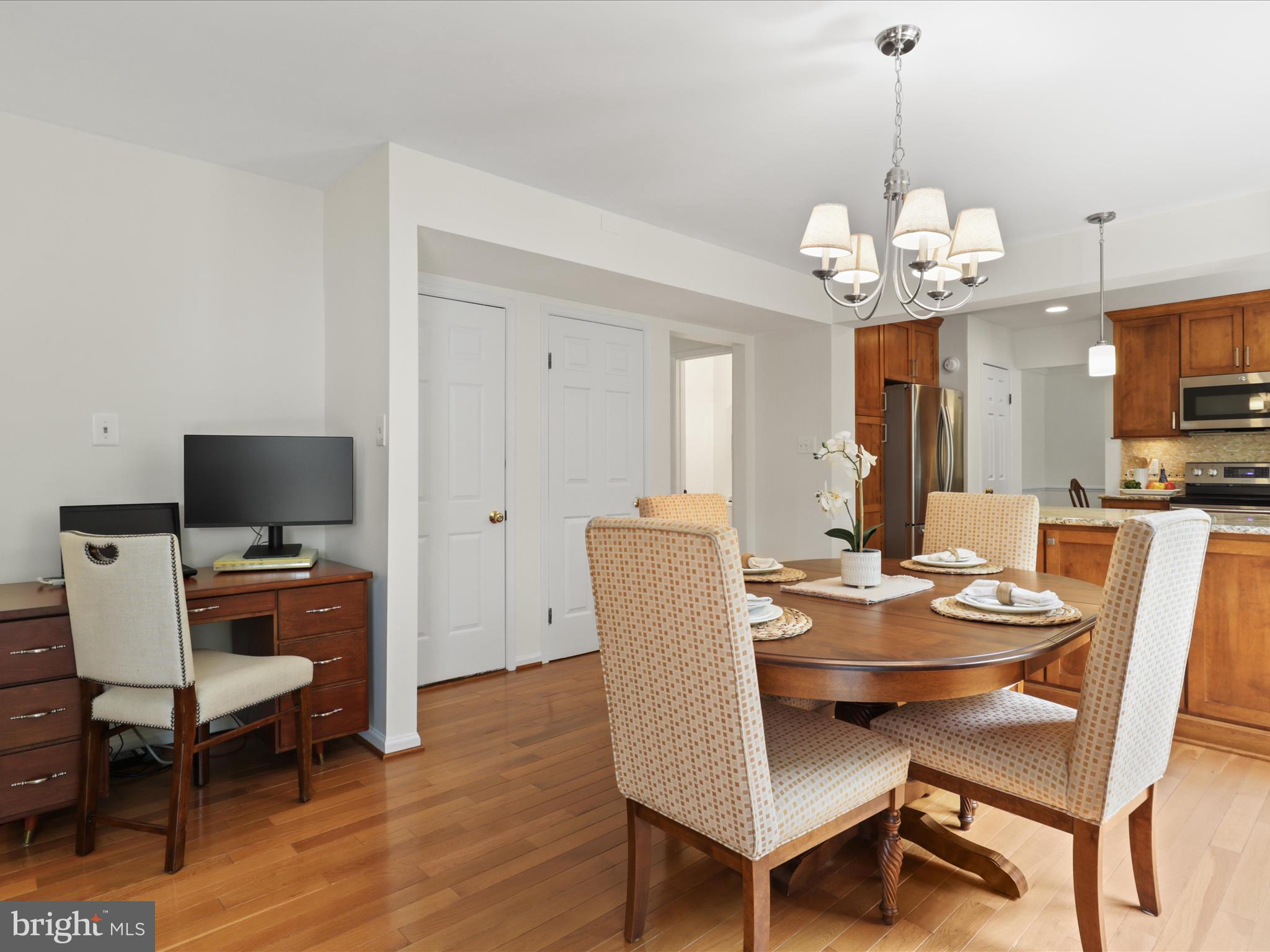 12021 Heather Down Drive Herndon, VA 20170 - Photo 18 of 47 a view of a dining room with furniture a chandelier and wooden floor