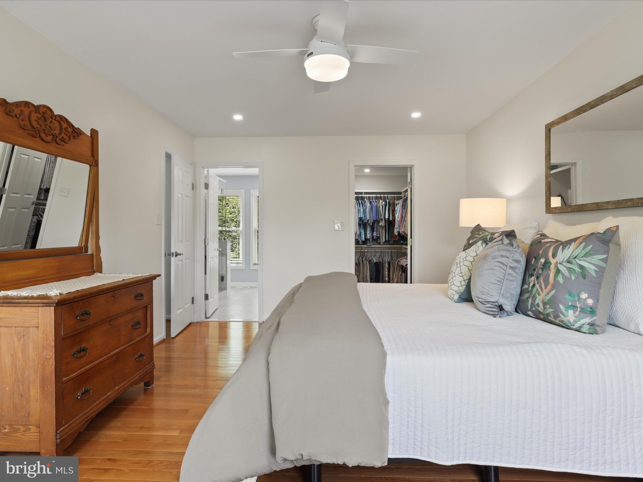 12021 Heather Down Drive Herndon, VA 20170 - Photo 24 of 47 a spacious bedroom with a bed and a dresser in it