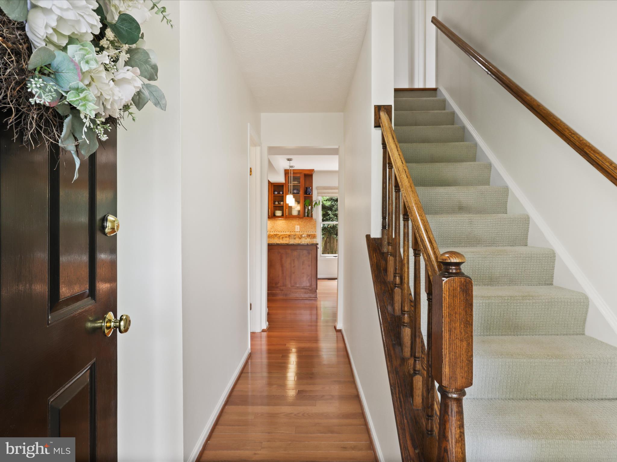 12021 Heather Down Drive Herndon, VA 20170 - Photo 39 of 47 a view of a hallway with wooden floor and stairs