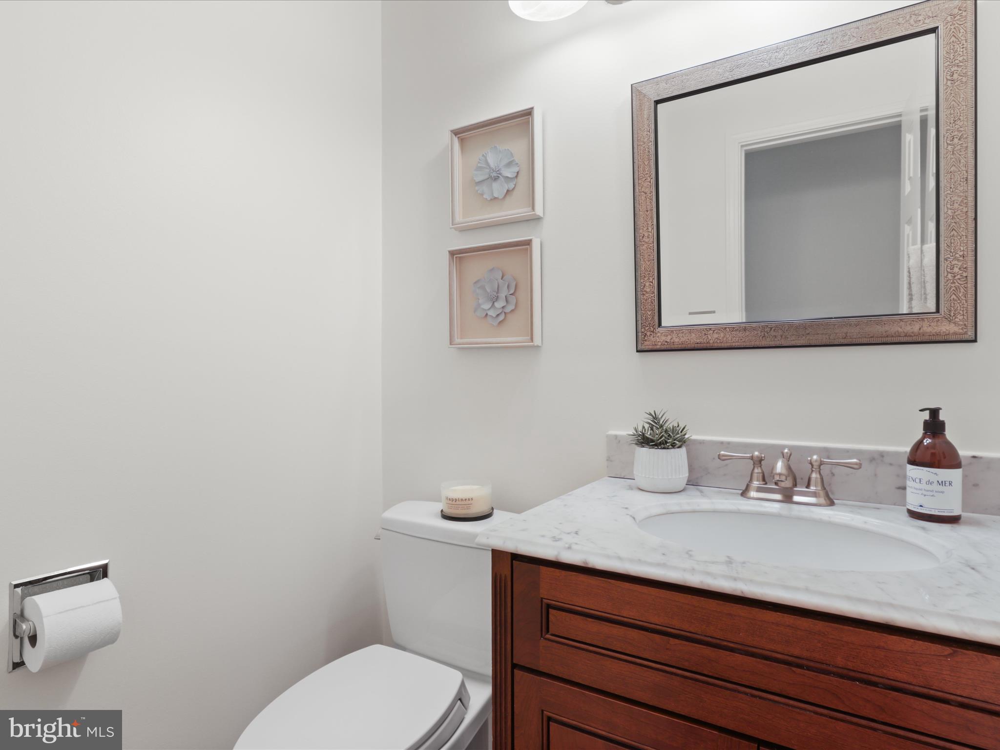 12021 Heather Down Drive Herndon, VA 20170 - Photo 8 of 47 a bathroom with a toilet a sink and mirror