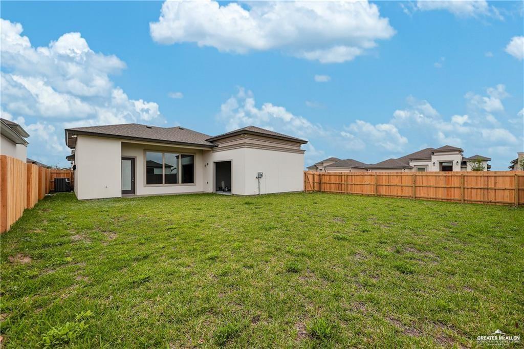 2516 Viola Street Mission, TX 78574 - Photo 15 of 17 Back of house featuring a fenced backyard and stucco siding