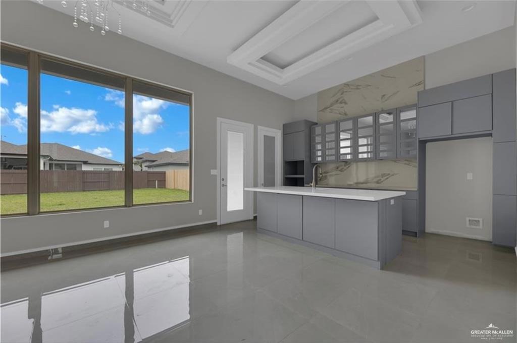 2516 Viola Street Mission, TX 78574 - Photo 2 of 17 Kitchen with gray cabinets, light countertops, modern cabinets, and a center island with sink