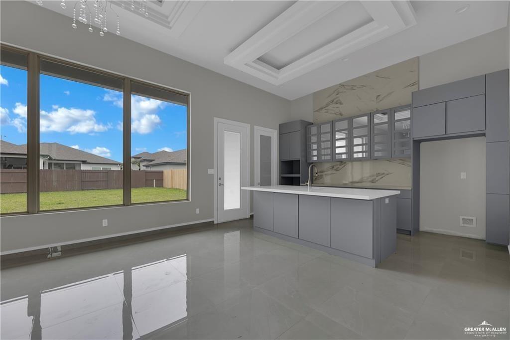 2516 Viola Street Mission, TX 78574 - Photo 6 of 17 Kitchen with gray cabinetry, light countertops, modern cabinets, and healthy amount of natural light