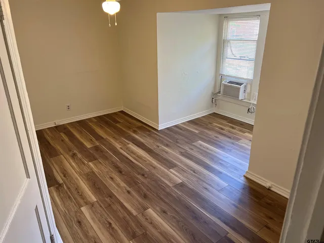 a view of a room with wooden floor and staircase