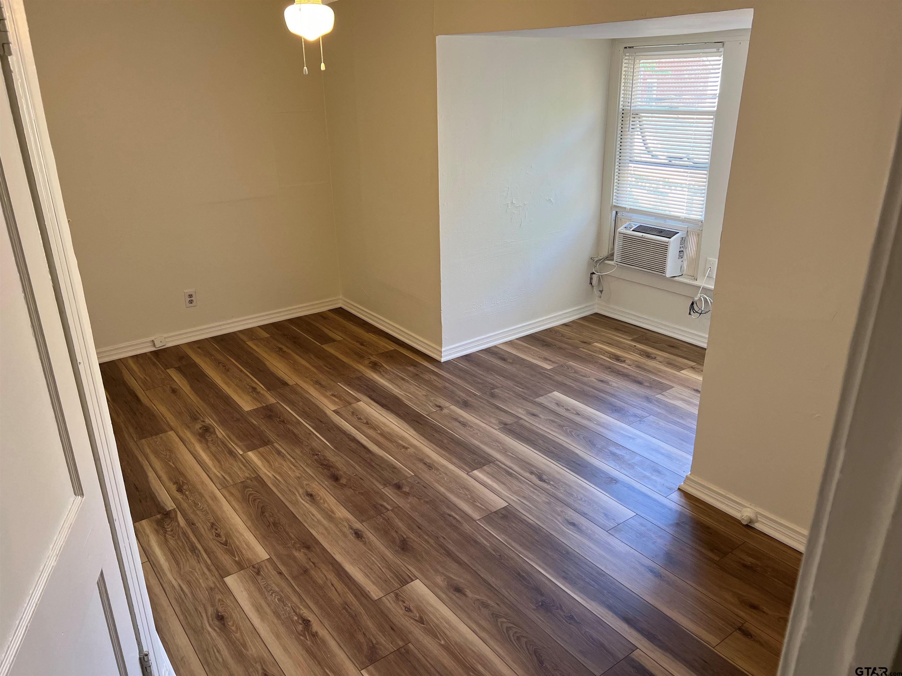 219 Wells Street, Unit C Tyler, TX 75701 - Photo 7 of 8 a view of a room with wooden floor and staircase
