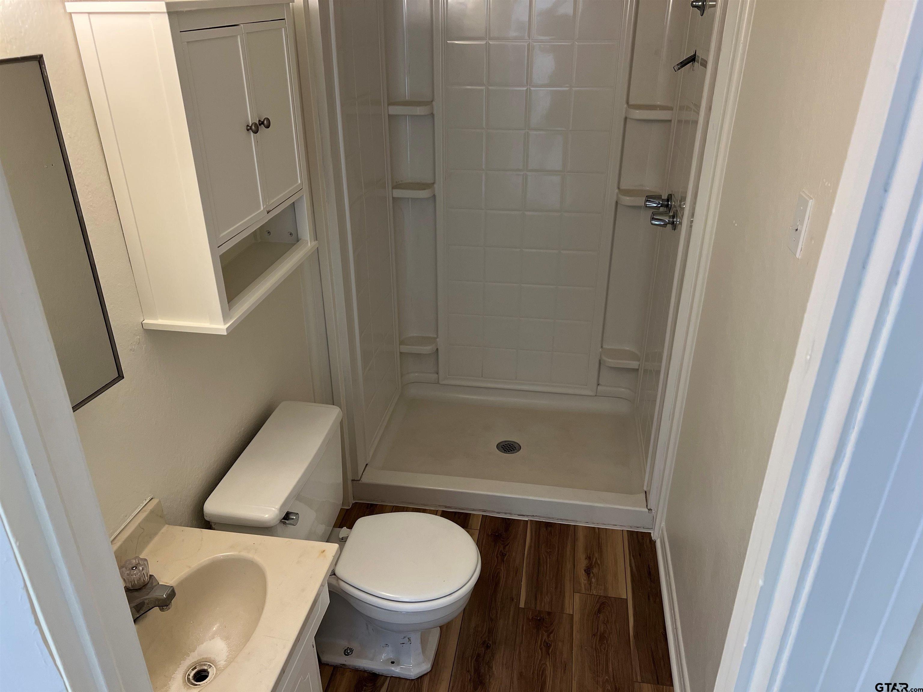 219 Wells Street, Unit C Tyler, TX 75701 - Photo 8 of 8 a bathroom with a sink and a toilet