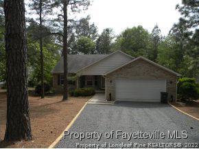 55 Sawmill Road West Pinehurst, NC 28374 - Photo 10 of 10 a house with trees in the background