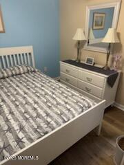 433 West Avenue, Unit 1 Ocean City, NJ 08226 - Photo 12 of 29 a bed sitting in a bedroom next to a lamp
